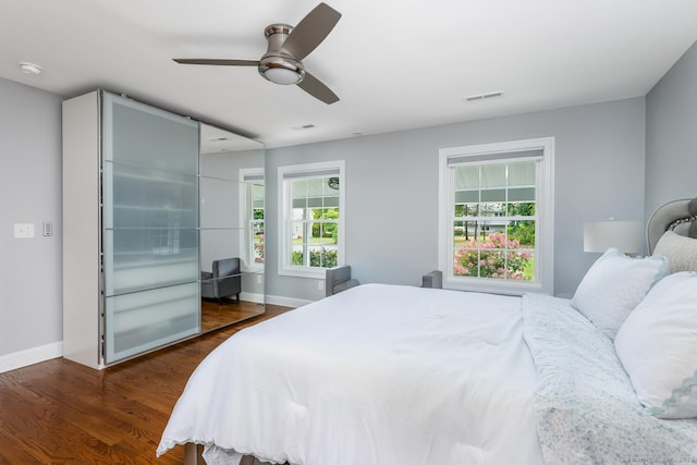 bedroom featuring dark hardwood / wood-style flooring and ceiling fan