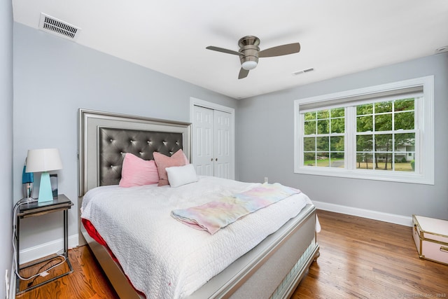 bedroom with hardwood / wood-style floors, a closet, and ceiling fan