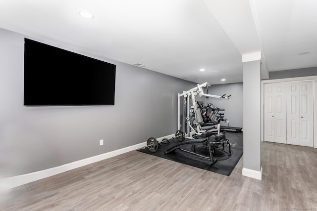 workout room with light hardwood / wood-style flooring