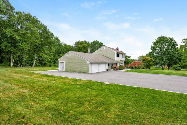 view of side of home with a garage and a yard