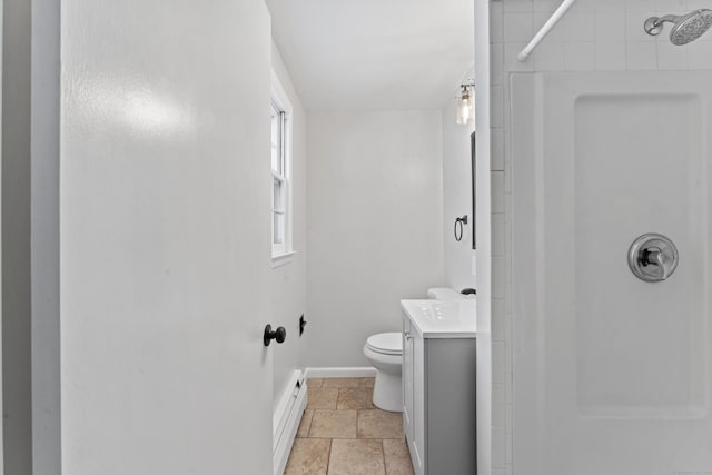 bathroom featuring vanity, toilet, baseboard heating, and walk in shower