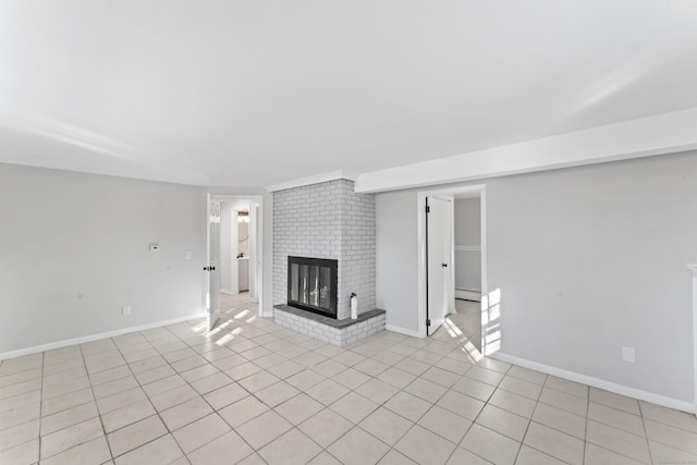 unfurnished living room featuring a brick fireplace and light tile patterned floors