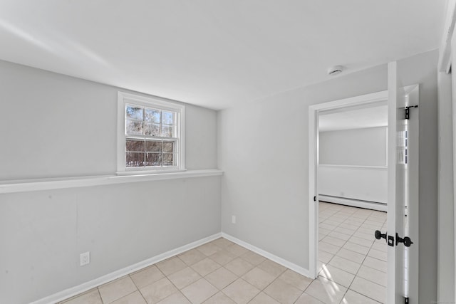 tiled empty room with a baseboard radiator