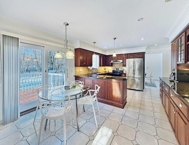 kitchen with appliances with stainless steel finishes, sink, backsplash, hanging light fixtures, and crown molding