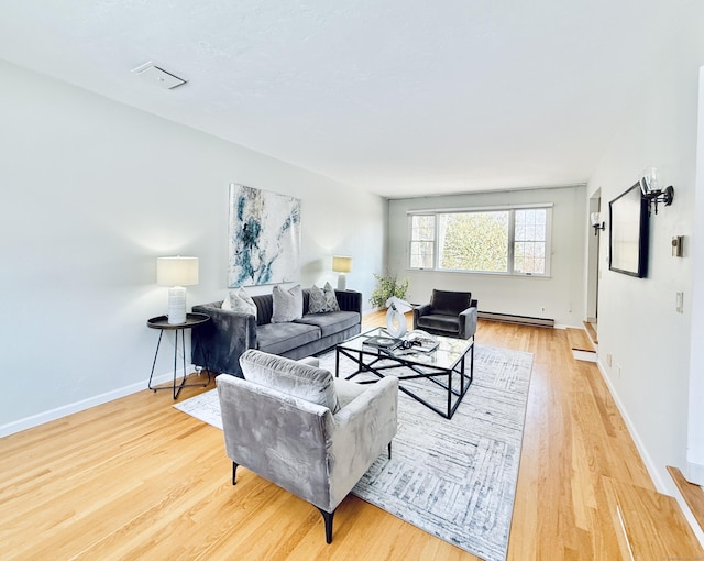 living room with light hardwood / wood-style floors and baseboard heating