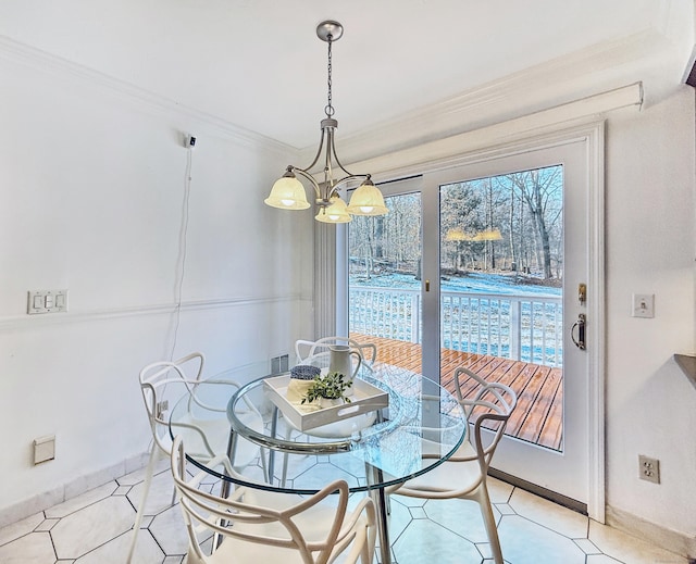 tiled dining area with crown molding and a notable chandelier