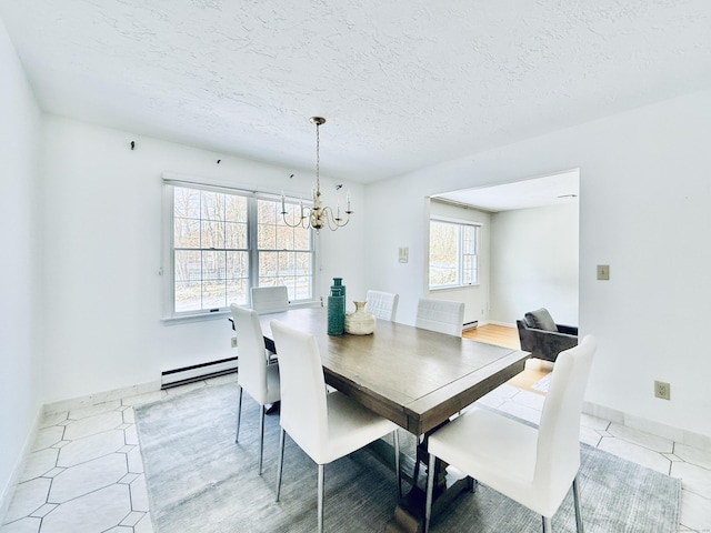 dining room featuring an inviting chandelier, a baseboard radiator, and a textured ceiling