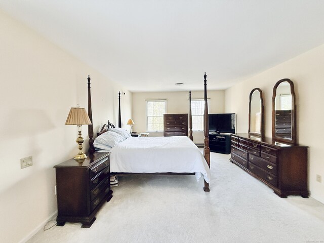 bedroom featuring light carpet