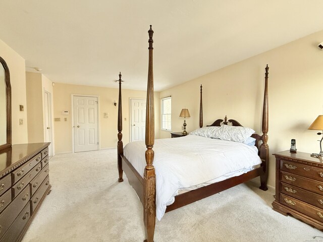 bedroom featuring light carpet