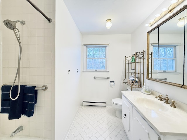 bathroom featuring a healthy amount of sunlight, toilet, vanity, and a baseboard heating unit