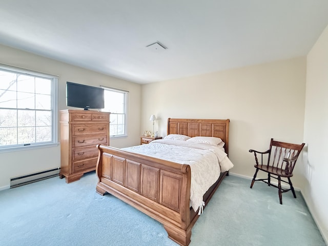 carpeted bedroom with a baseboard radiator and multiple windows