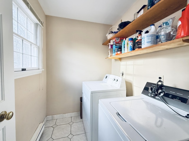 clothes washing area with washing machine and clothes dryer, a baseboard heating unit, and light tile patterned floors