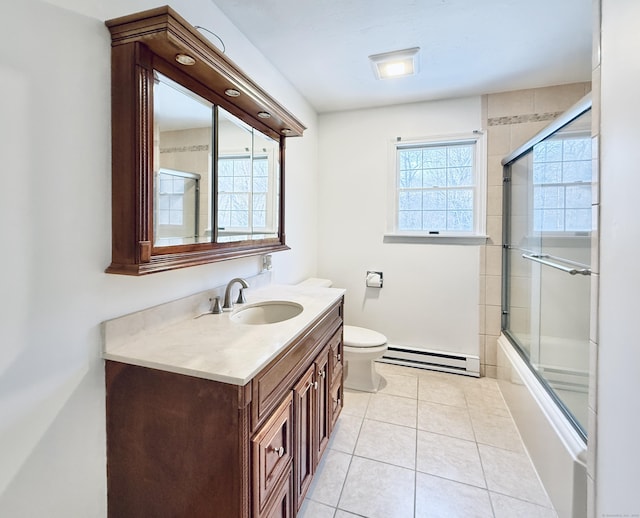 full bathroom with baseboard heating, tile patterned flooring, bath / shower combo with glass door, vanity, and toilet