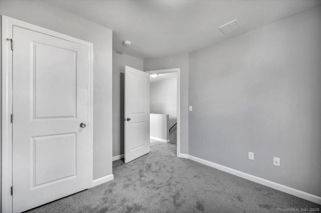 unfurnished bedroom with light colored carpet