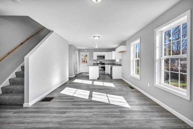 unfurnished living room featuring dark hardwood / wood-style flooring and sink