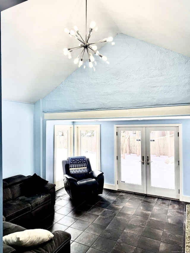 living room featuring a chandelier, vaulted ceiling, and french doors