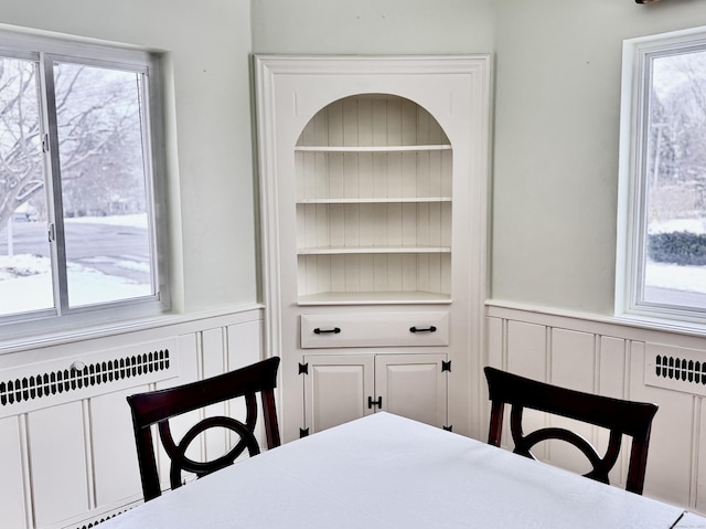 dining room featuring built in shelves and radiator heating unit