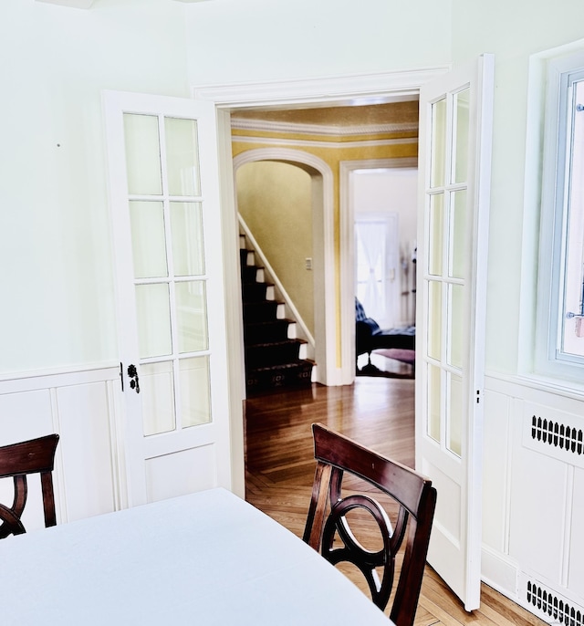 dining area featuring radiator and hardwood / wood-style flooring