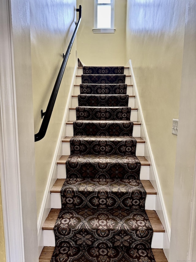 stairs featuring hardwood / wood-style flooring