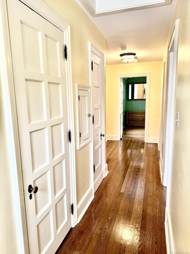 corridor with dark hardwood / wood-style floors