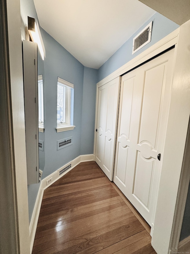 hallway featuring dark hardwood / wood-style floors