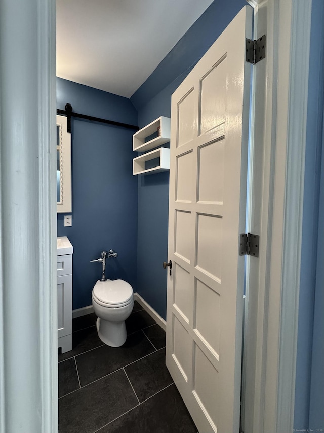 bathroom featuring tile patterned flooring, vanity, and toilet