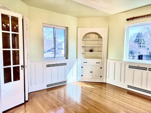 entryway featuring radiator, light hardwood / wood-style floors, and built in features