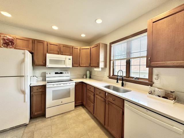 kitchen featuring sink, white appliances, and light tile patterned floors