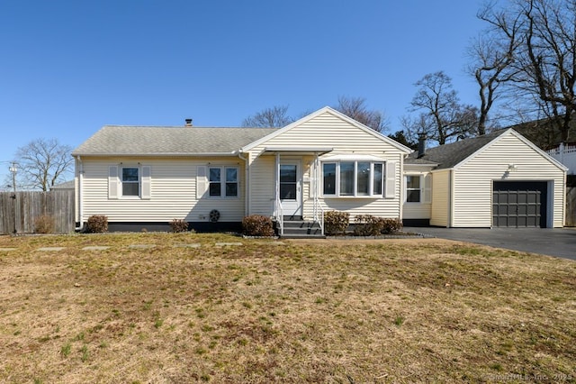 ranch-style house featuring a garage and a front lawn