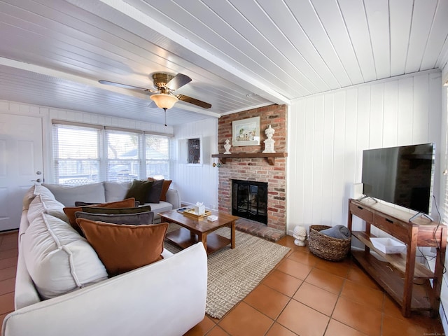 tiled living room featuring a brick fireplace, wooden ceiling, and ceiling fan