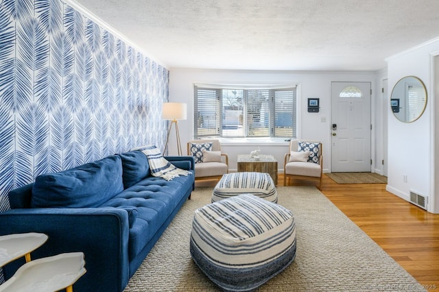 living room featuring wood-type flooring and a textured ceiling