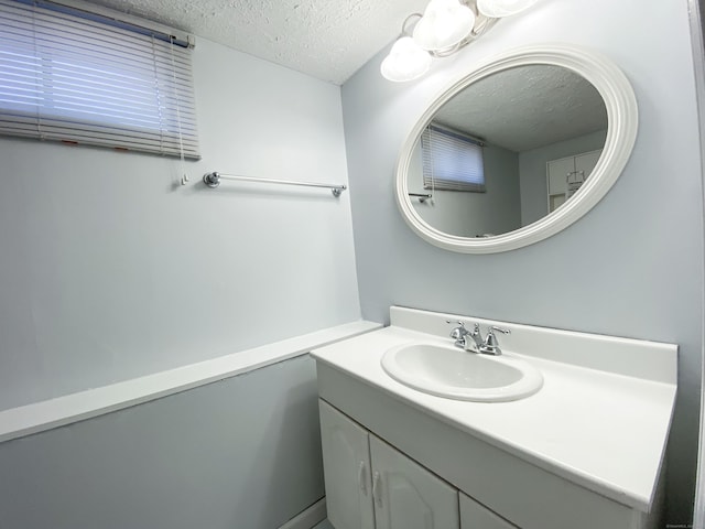 bathroom with vanity and a textured ceiling