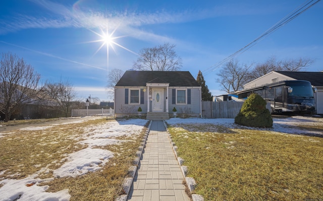 bungalow-style house with a front lawn