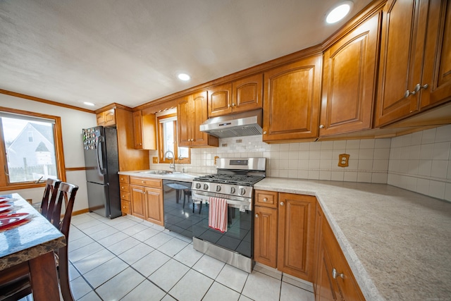 kitchen featuring sink, light tile patterned flooring, crown molding, black appliances, and decorative backsplash