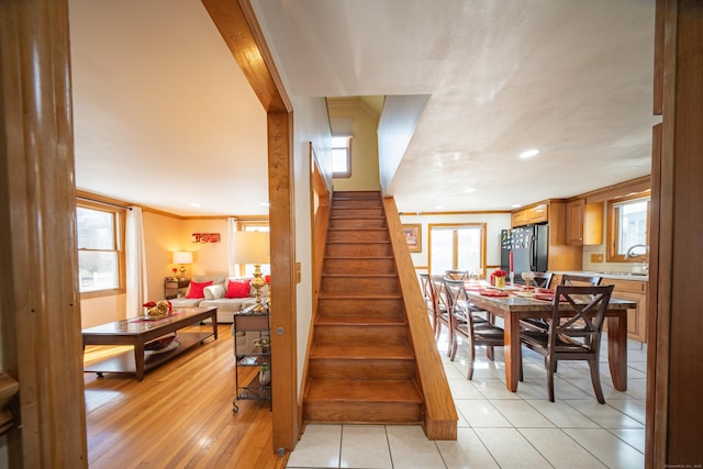 stairs featuring hardwood / wood-style flooring and crown molding