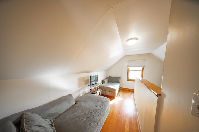 bedroom featuring lofted ceiling and light wood-type flooring