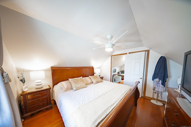 bedroom with lofted ceiling, ceiling fan, and wood-type flooring