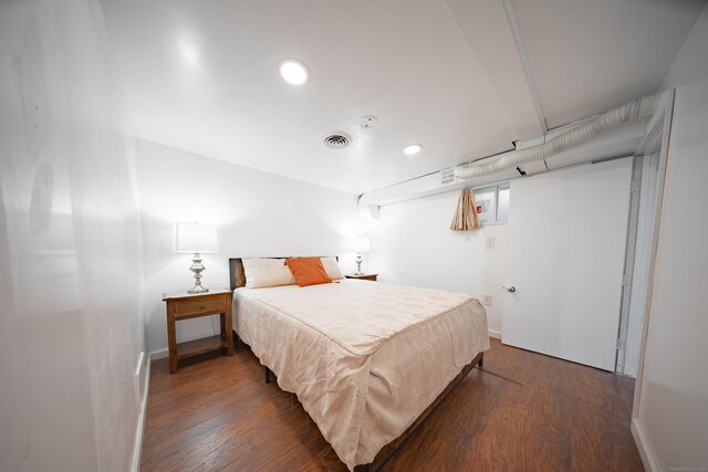 bedroom with dark hardwood / wood-style flooring