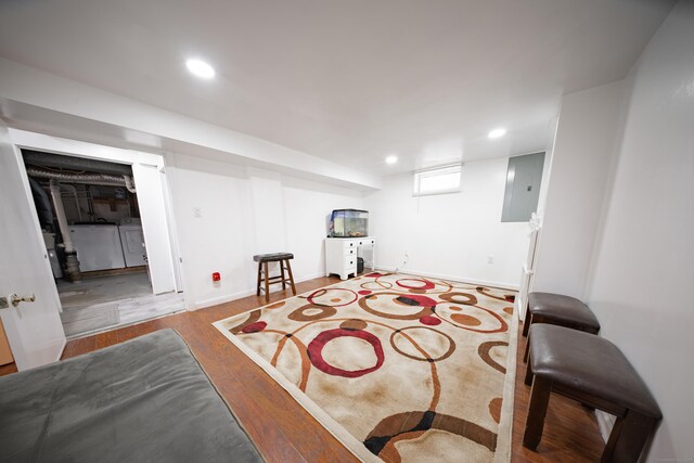 interior space with separate washer and dryer, wood-type flooring, and electric panel