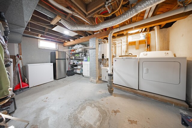 basement featuring fridge, washing machine and clothes dryer, and stainless steel fridge