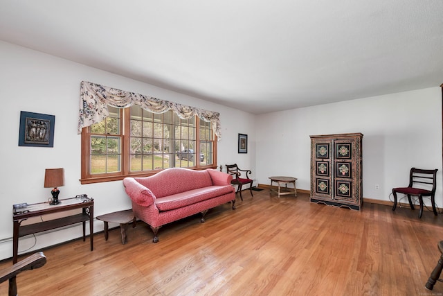 living area featuring wood-type flooring and baseboard heating