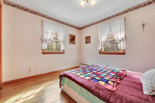 bedroom featuring light hardwood / wood-style flooring and baseboard heating