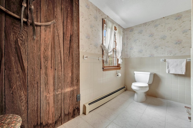 bathroom featuring a baseboard radiator, toilet, tile patterned flooring, and tile walls