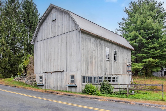 view of side of property with an outbuilding