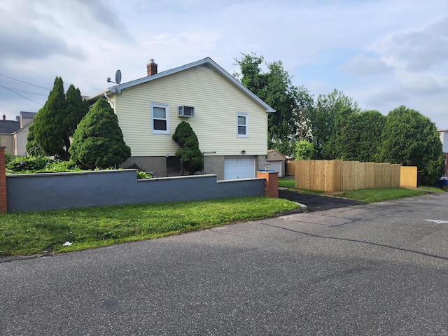 79 Addison St, Waterbury, CT 06708 - view of side of home with a chimney and an attached garage
