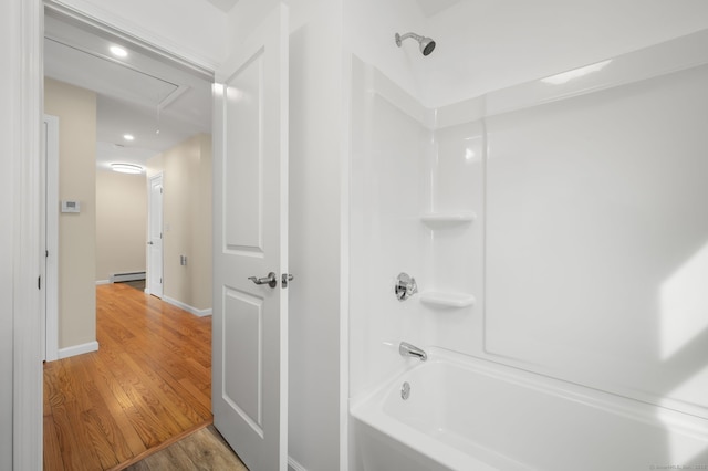 bathroom featuring baseboard heating, wood-type flooring, and bathing tub / shower combination