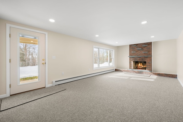 unfurnished living room featuring a fireplace, a baseboard radiator, and carpet