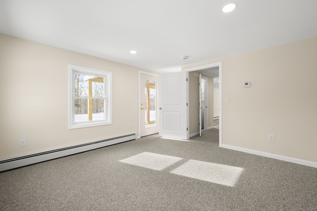 carpeted empty room with baseboard heating