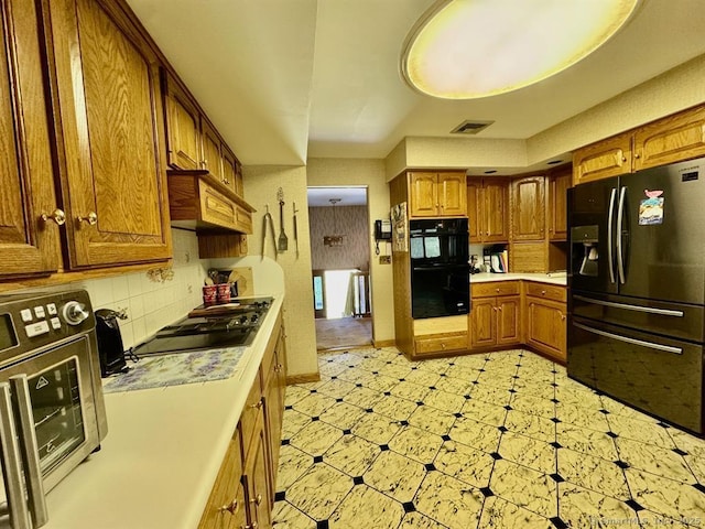 62 Rte 6n Rte, Carmel, NY 10541 - kitchen with brown cabinetry, light countertops, black appliances, and visible vents