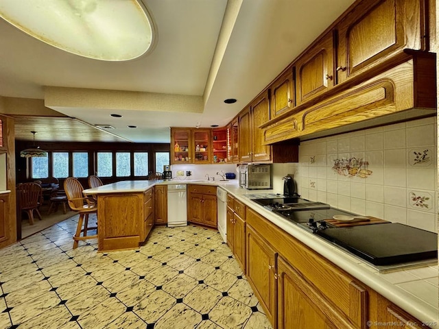 62 Rte 6n Rte, Carmel, NY 10541 - kitchen with a peninsula, white dishwasher, a breakfast bar area, black electric stovetop, and light countertops